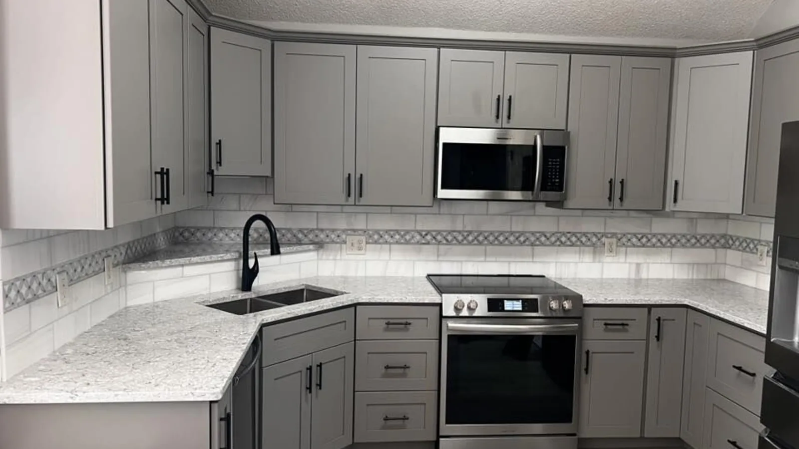 Freshly refinished gray shaker kitchen cabinets with new paint by H.E. Douglas in Savannah