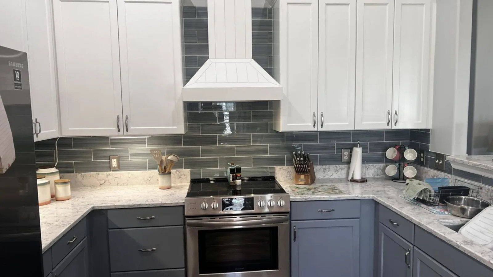 Finished two-tone white and gray kitchen remodel with subway tile backsplash by H.E. Douglas in Savannah