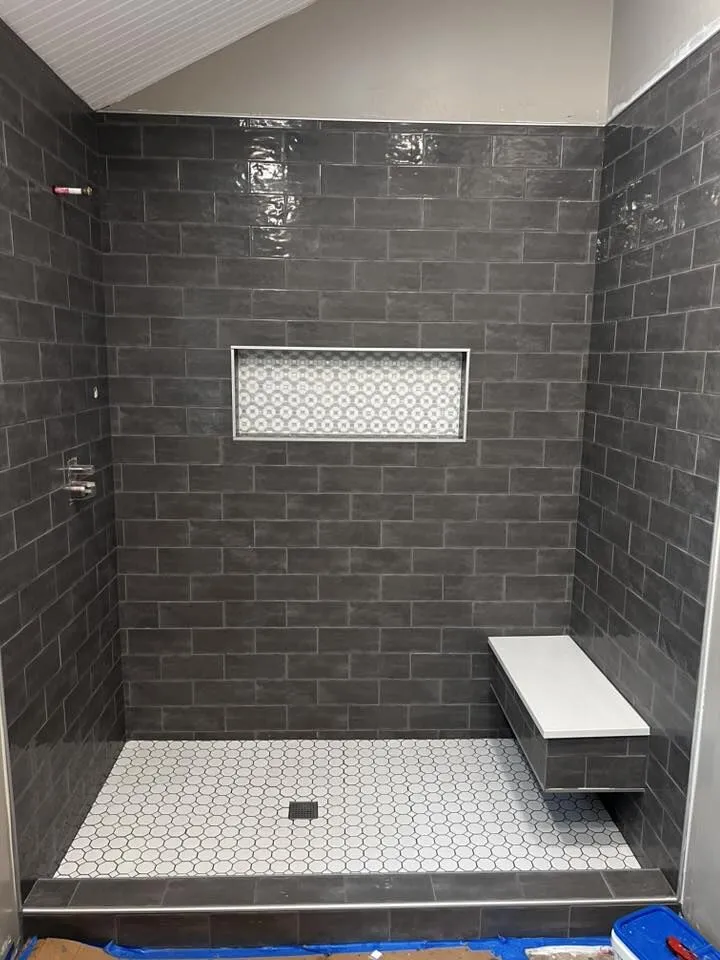 Charcoal subway tile walk-in shower with a recessed niche built by H.E. Douglas in Savannah