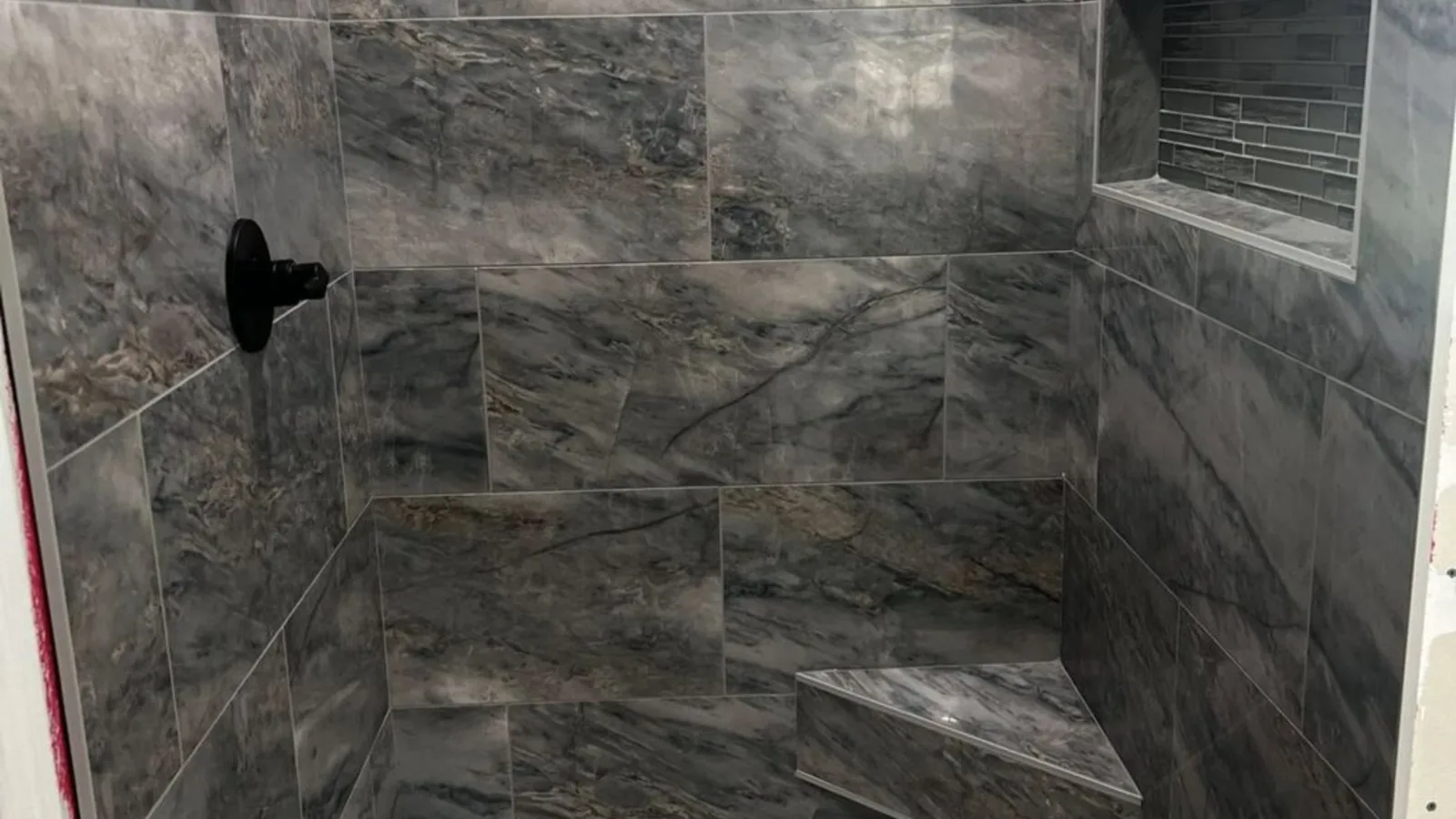 Charcoal large-format tile curbless walk-in shower built by H.E. Douglas in Savannah