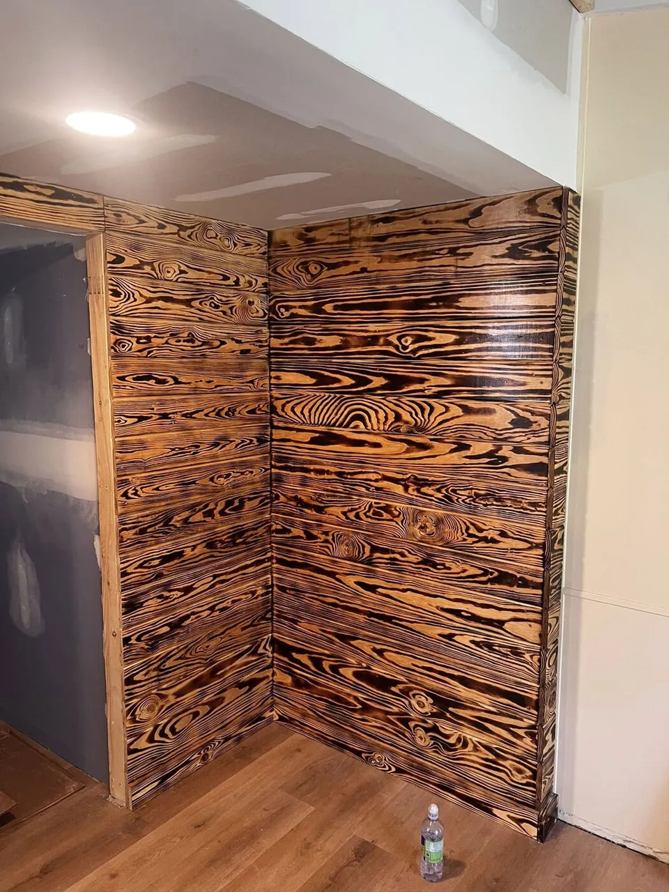 Burnt-finish shou-sugi-ban wood accent wall feature in a living space